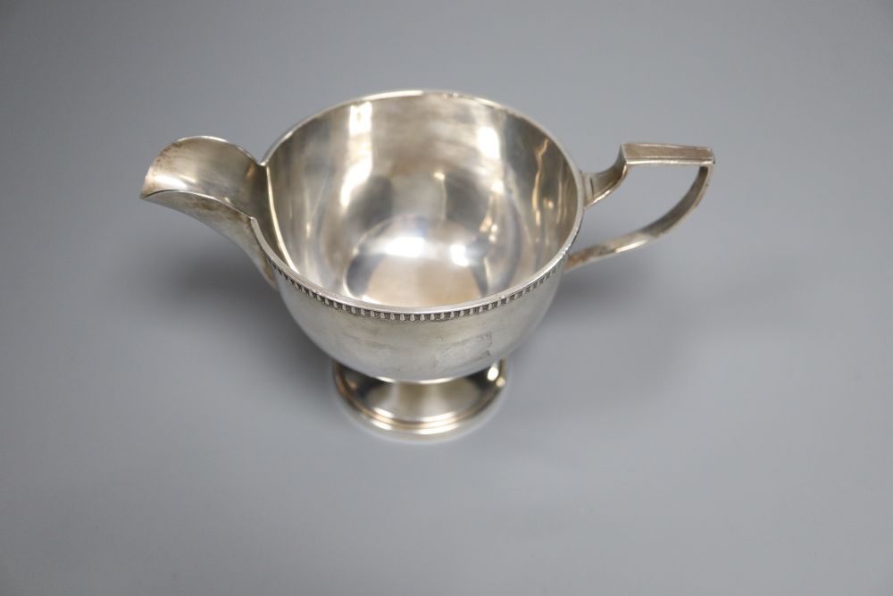 A George V silver pedestal cream jug, Walker & Hall, Sheffield, 1930, 85mm,